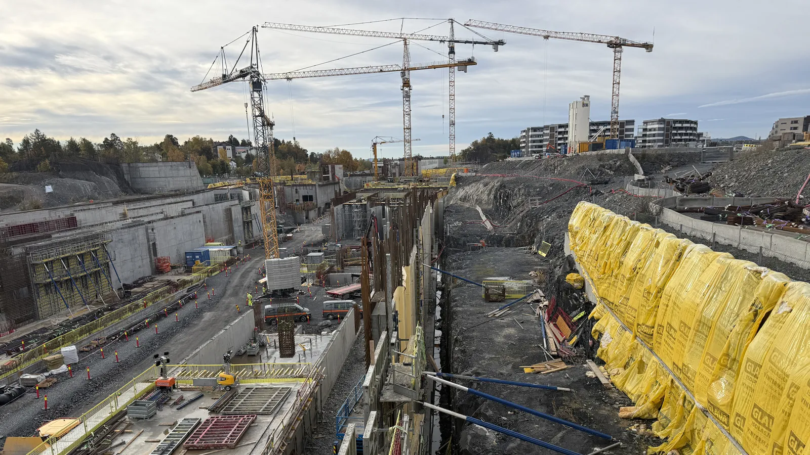 Leca® Lettklinker blåst på plass mellom betongvegg og spunt på Fornebu stasjon.